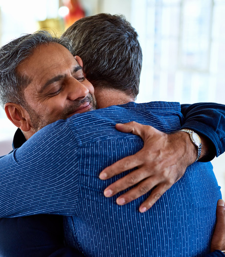 Two men hugging 